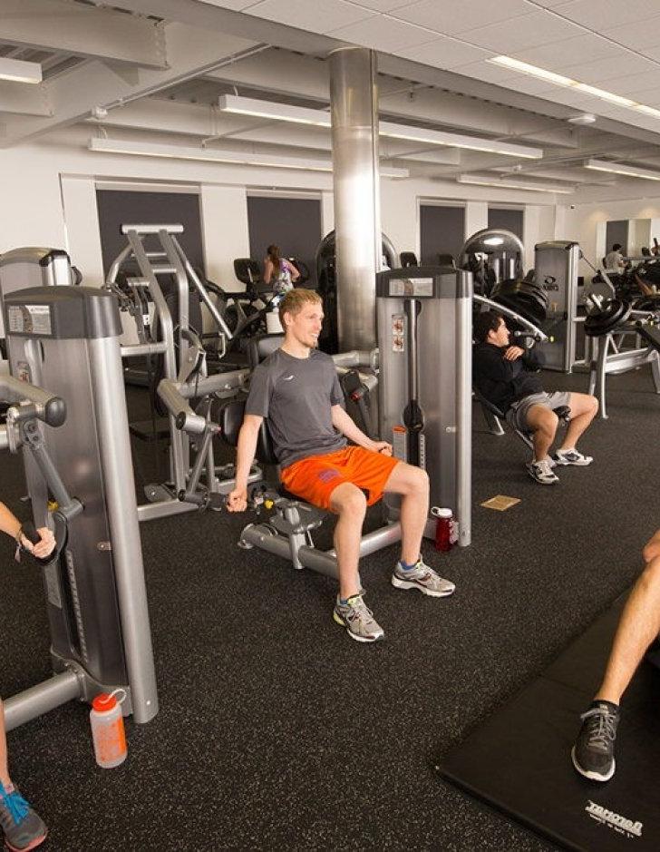 Students use exercise machines in the Gold Student Center gym