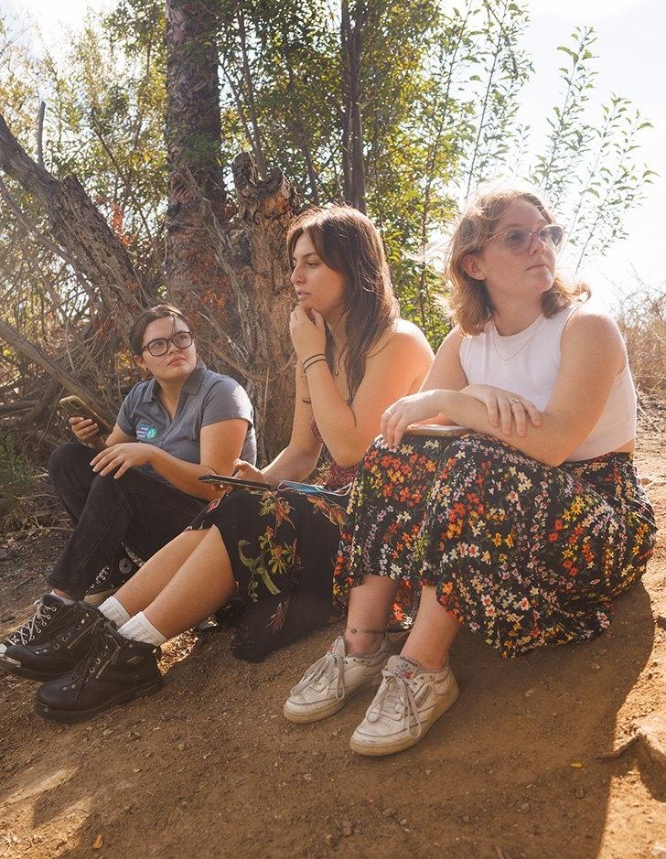 three students sit in the bernard field station